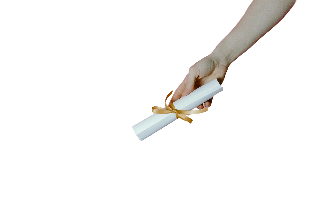 A hand holding a diploma tied with a golden ribbon