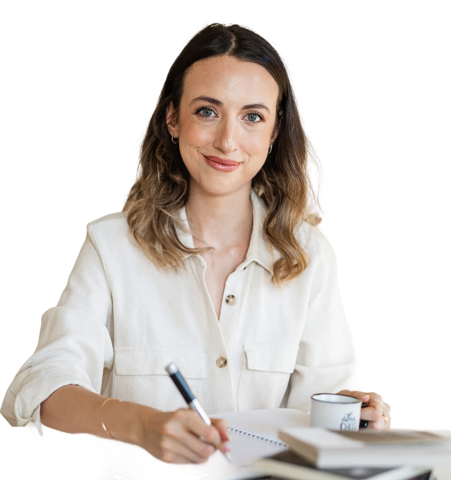 Jana writing notes in a notebook with a cup of coffee